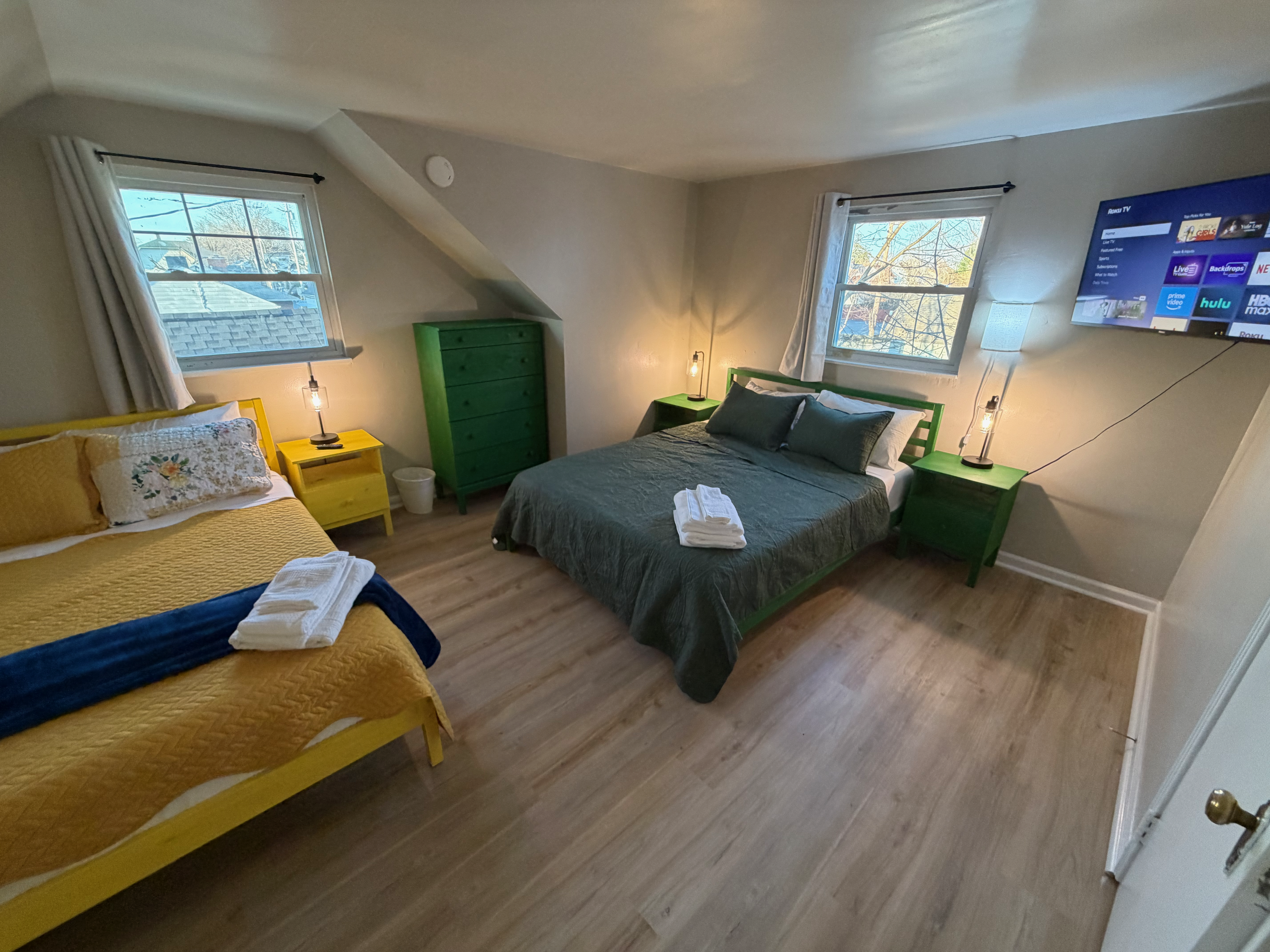 Green-themed bedroom with queen and twin beds at The Land of Cleve, Dayton OH